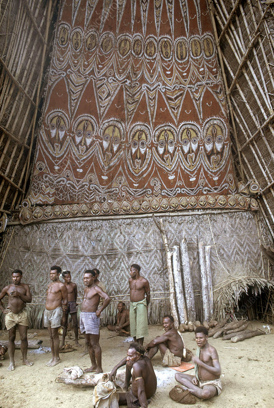 Tribal men in front of a Haus Tambaran near Mapik, East Sepik.