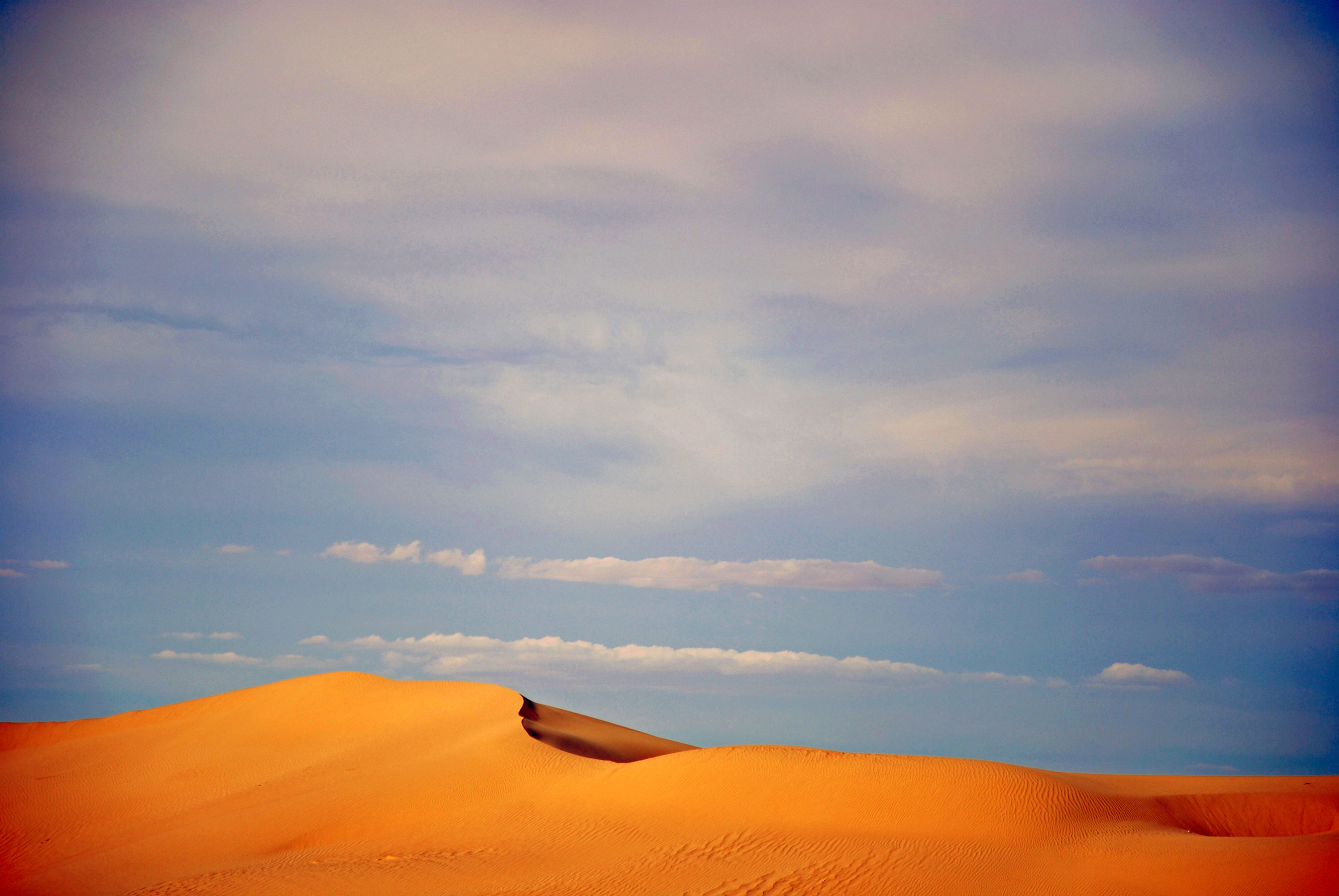 A barchan (crescent-shaped sand dune) at Ong-Jmel,