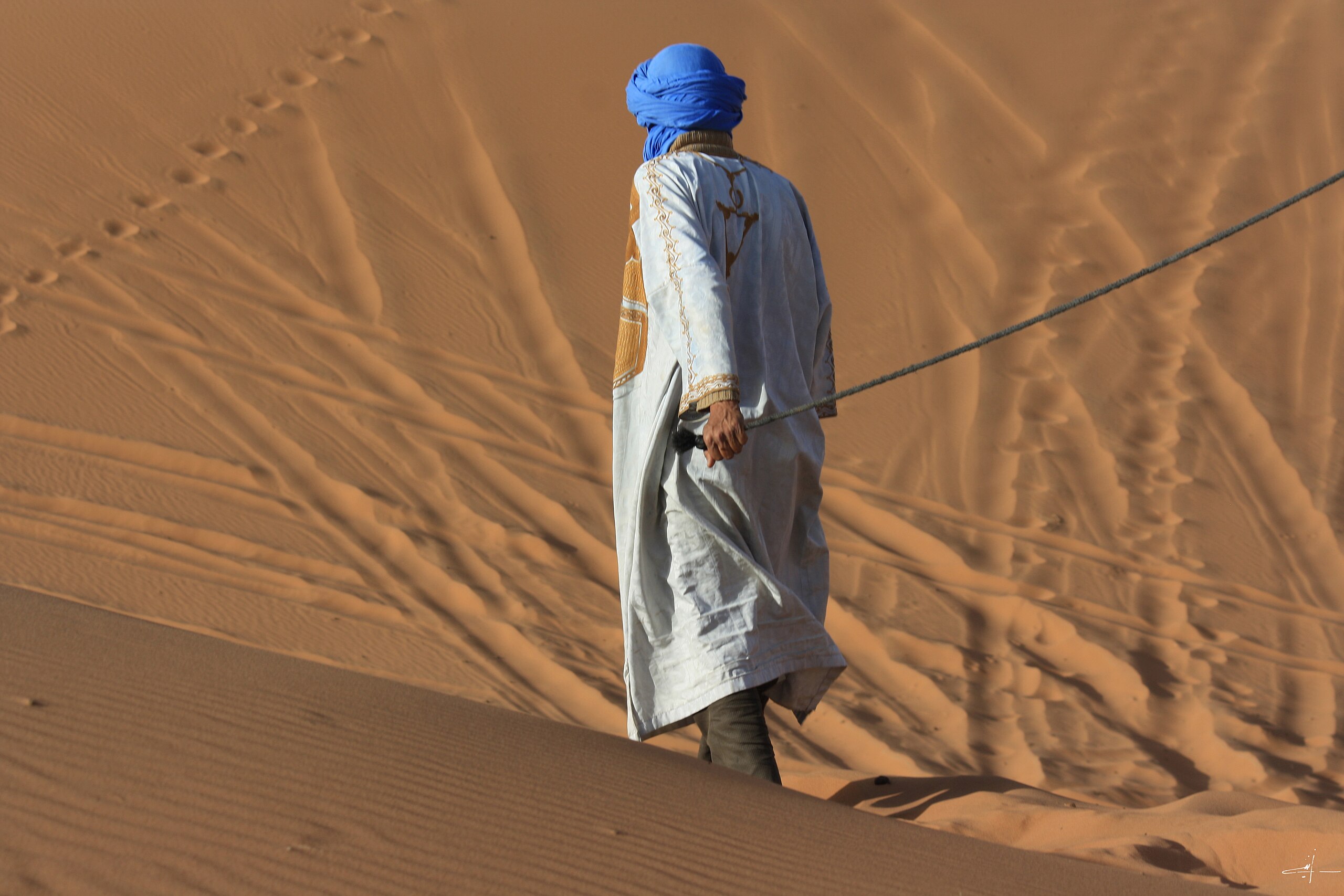 A Tuareg cameleer in the Moroccan Sahara.